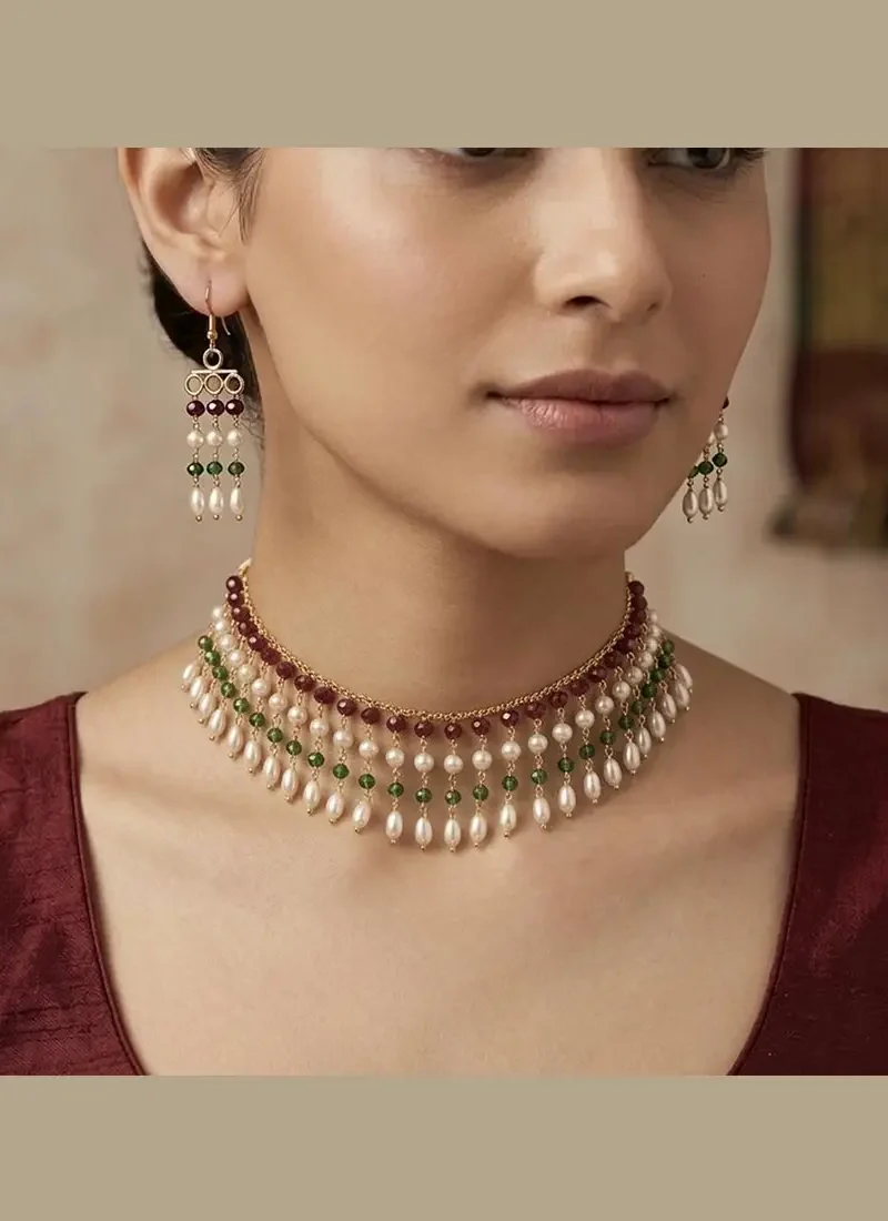 Elegant gold choker featuring sparkling red and green crystal accents with earrings