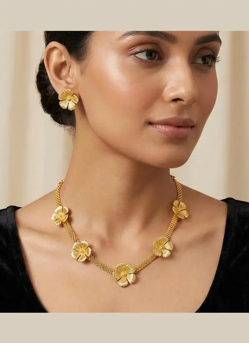 Elegant gold flower necklace with matching earrings