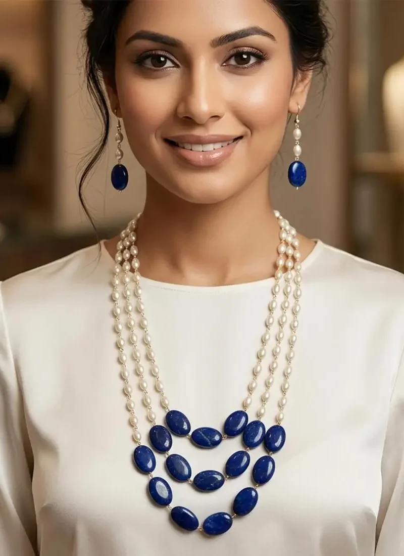 Faux pearl necklace with blue onyx stone set on a delicate gold chain with matching earrings