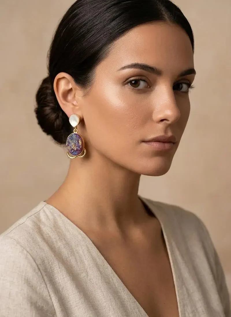 Mother of pearl stud with druzy stone hanging earrings on a gold base.