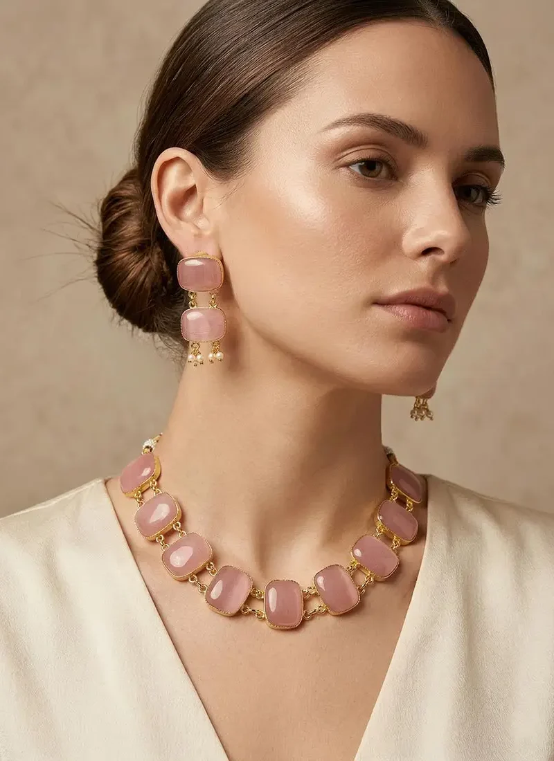 Gold necklace set featuring emerald blush pink Monalisa stones, paired with matching drop earrings.