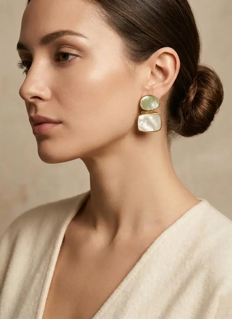 Mother of pearl statement earrings with a gold base.