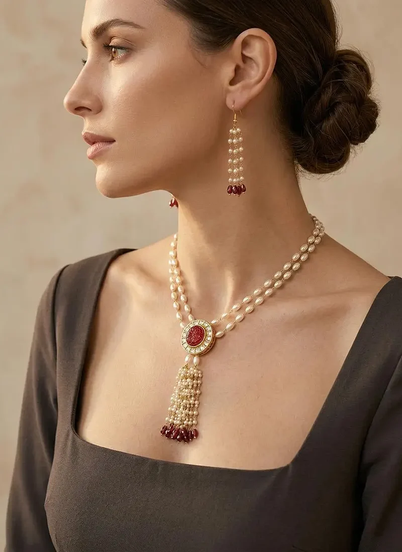 Ruby red Monalisa and kundan stone pendant with shell pearls on a gold base.