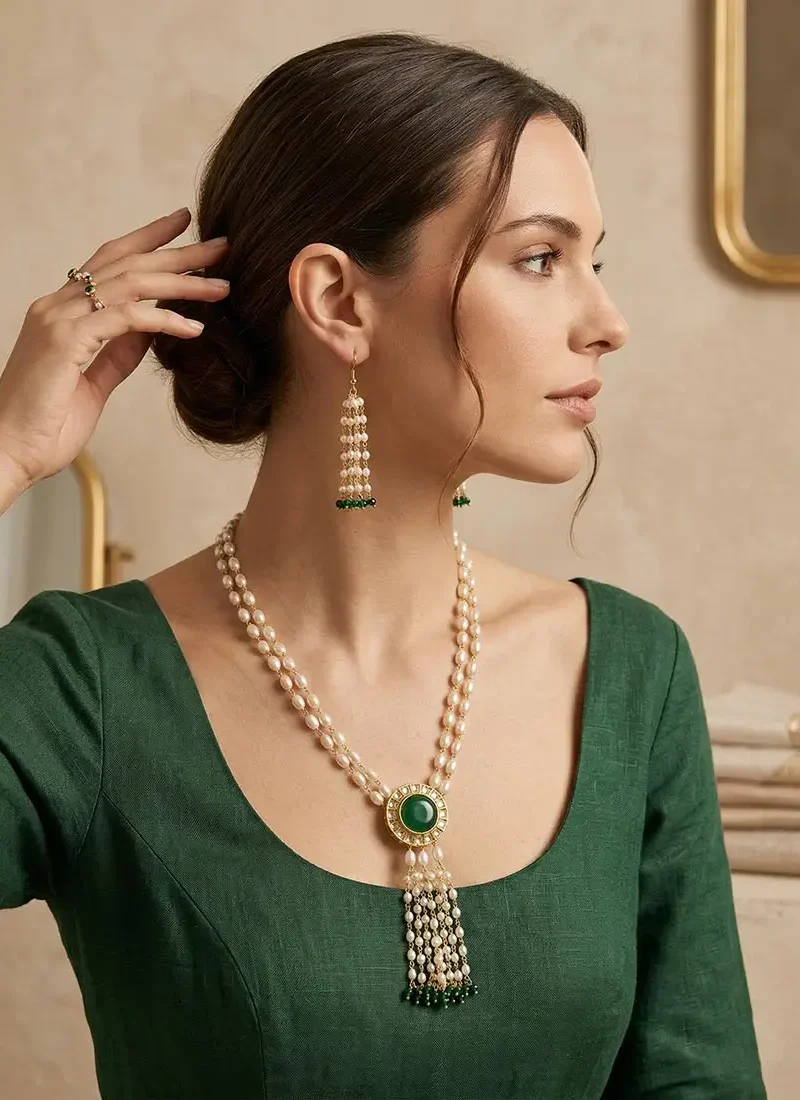 Emerald green Monalisa and kundan stone pendant with shell pearls on a gold base.