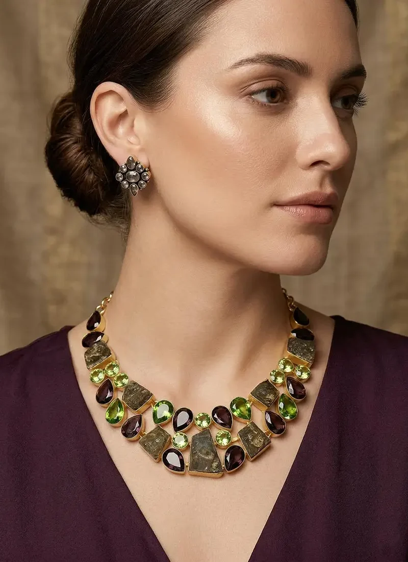 Raw garnet and green agate statement necklace  set in a gold base, paired with matching stud earrings.