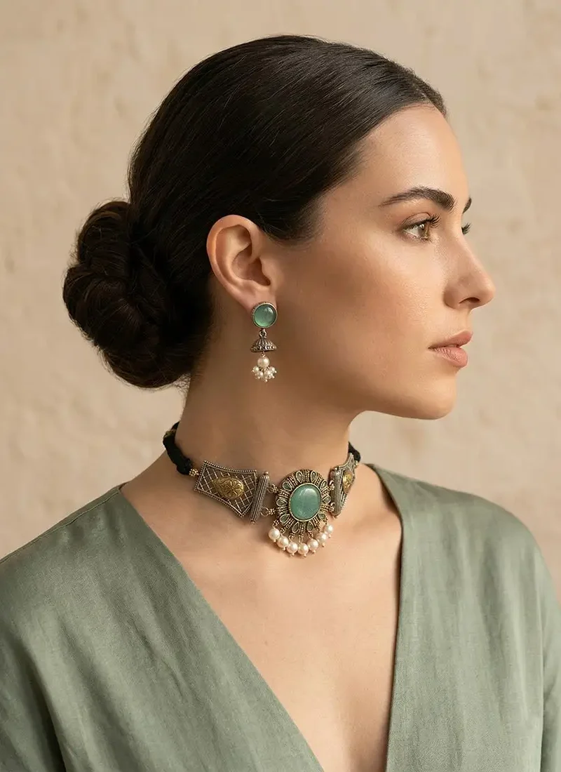 Antique silver earrings with green agate stone and pearl danglings, paired with matching earrings.