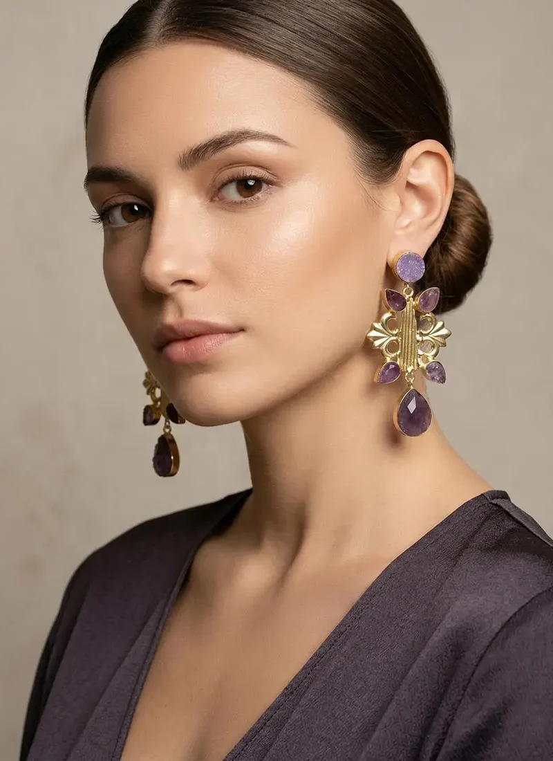 Raw amethyst earrings with a golden base.