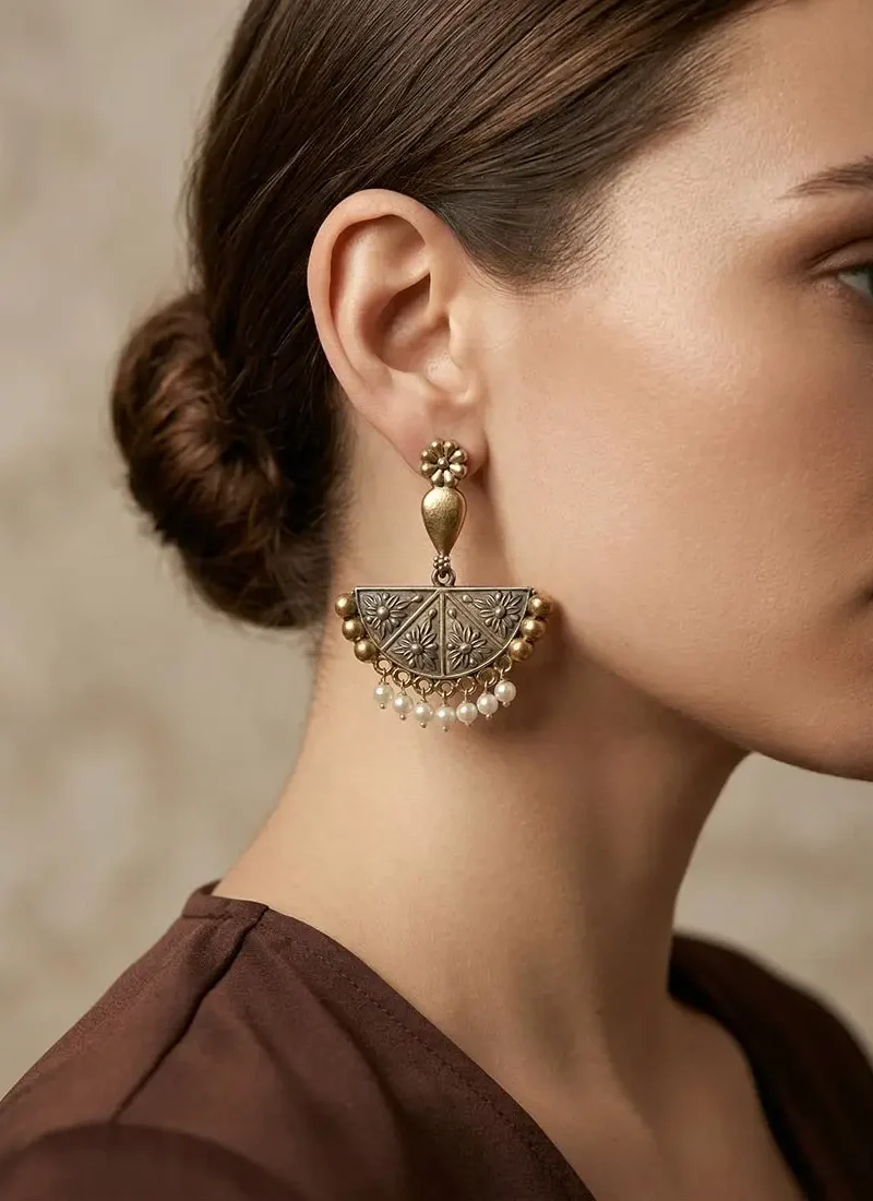 Antique silver earrings with intricate design and pearl danglings.