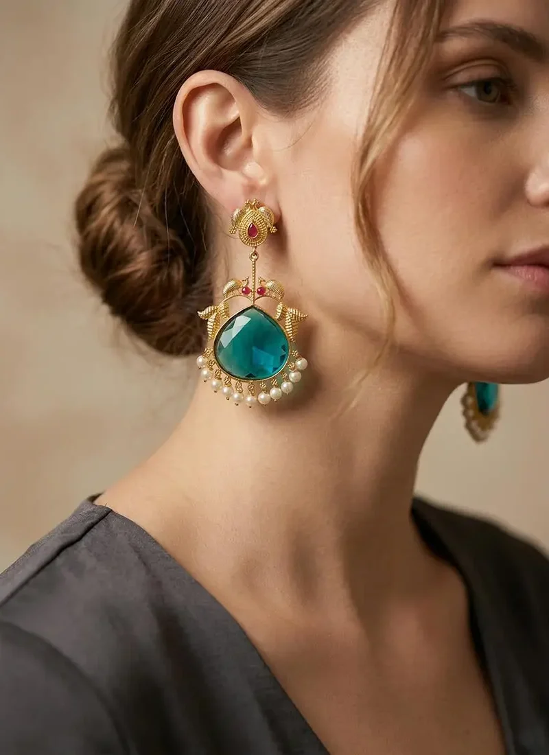Golden peacock adorned with a striking green agate stone with delicate pearl danglings