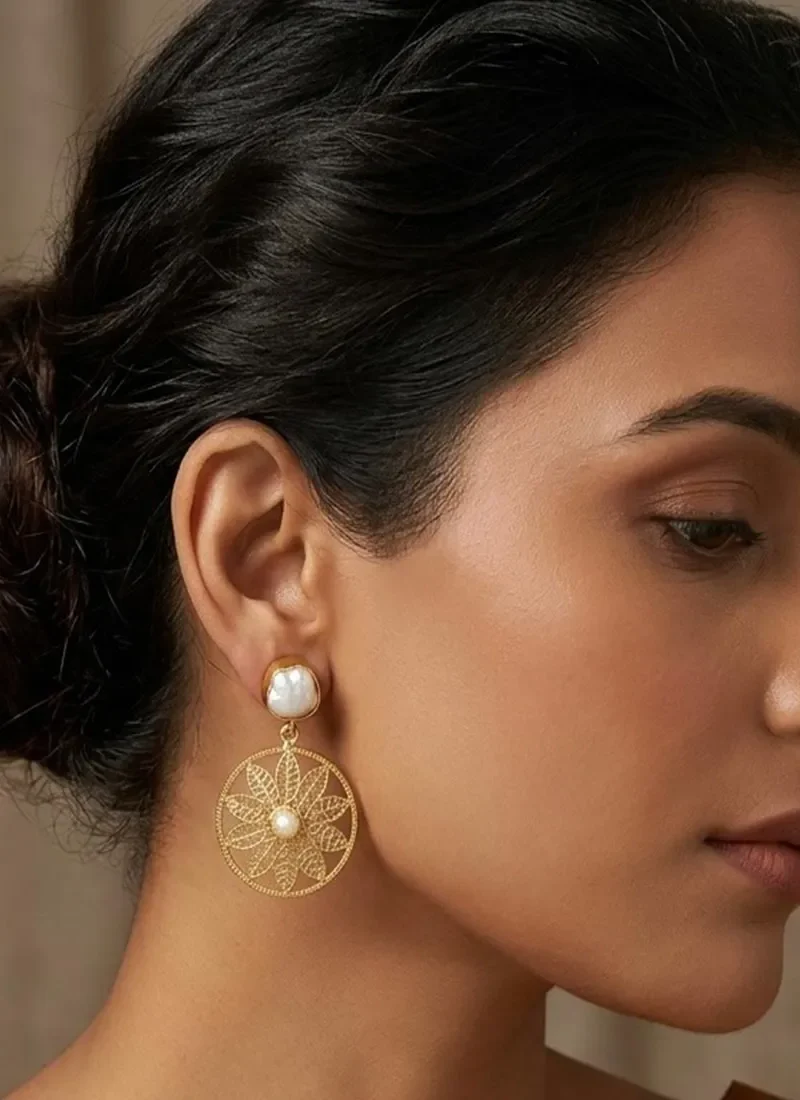 Gold floral design earrings with pearl button