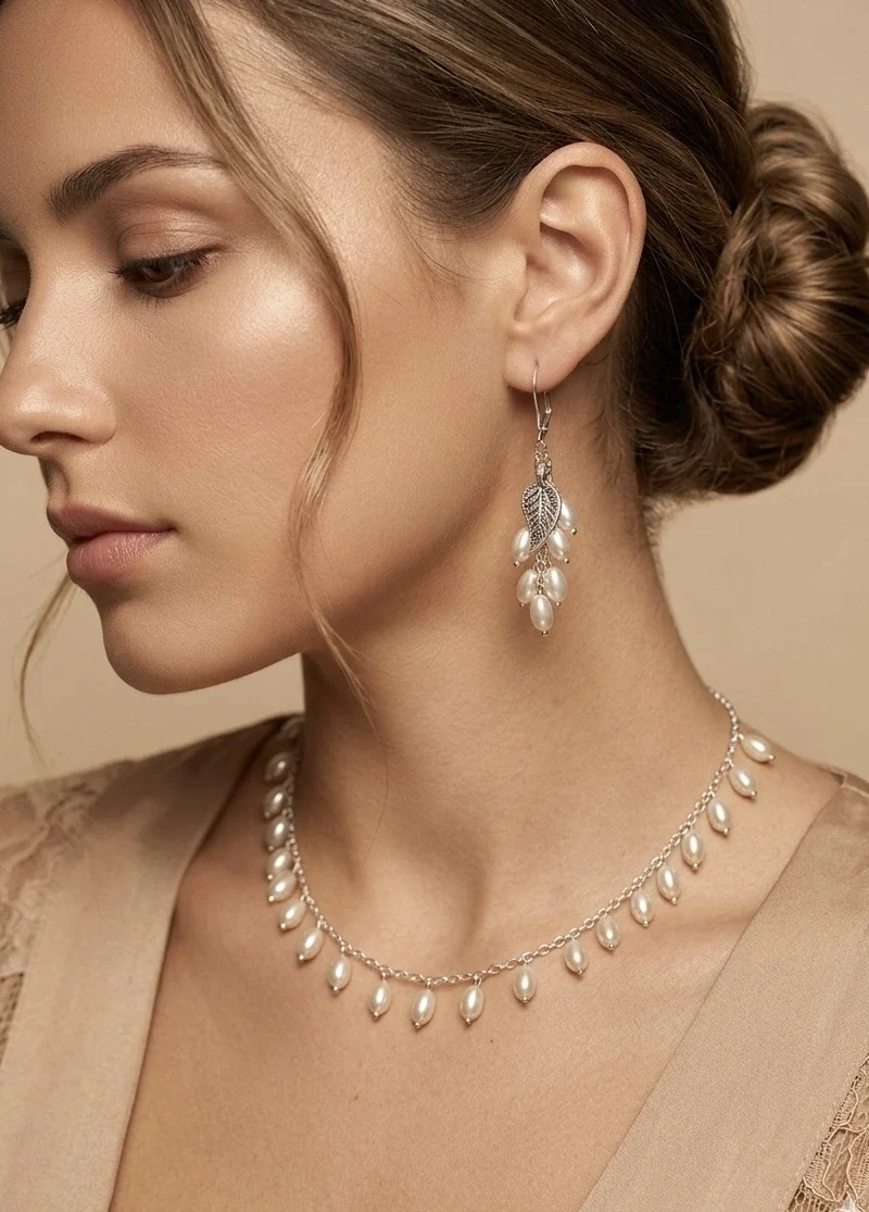 Silver chain with rice shell pearls, paired with matching earrings and bracelet.