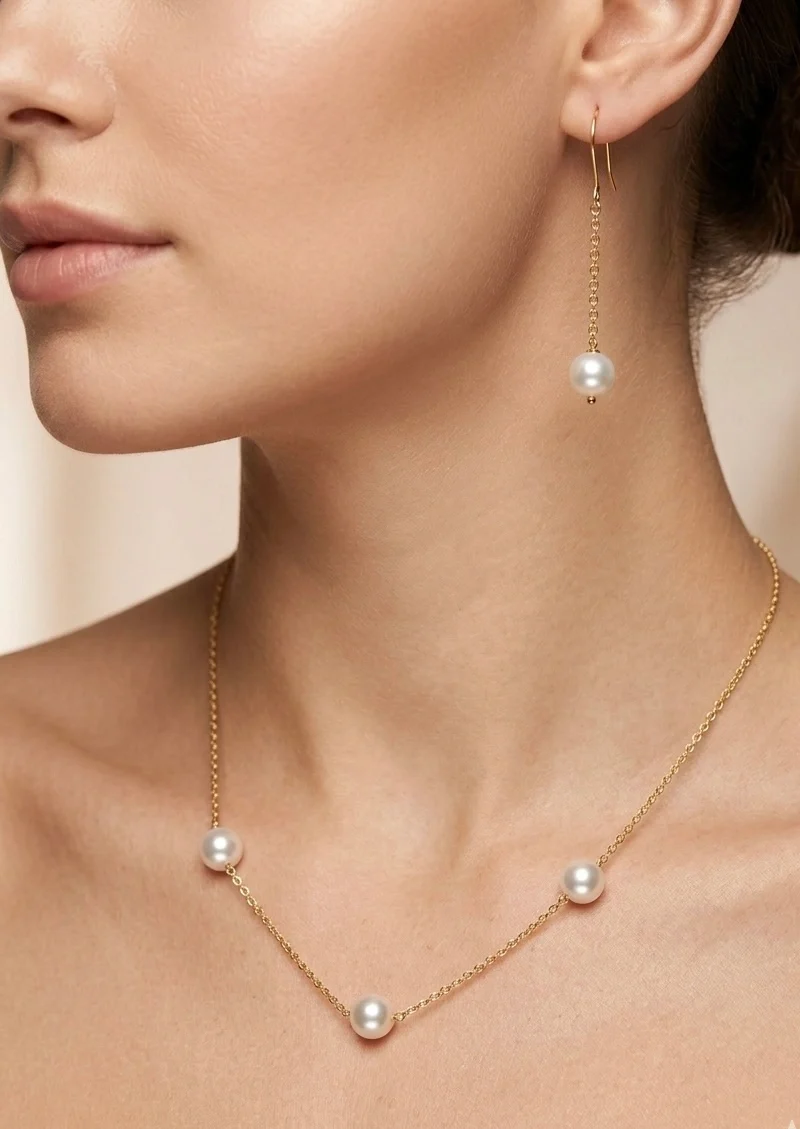 Delicate gold plated chain with shell pearl paired with earrings and bracelet.