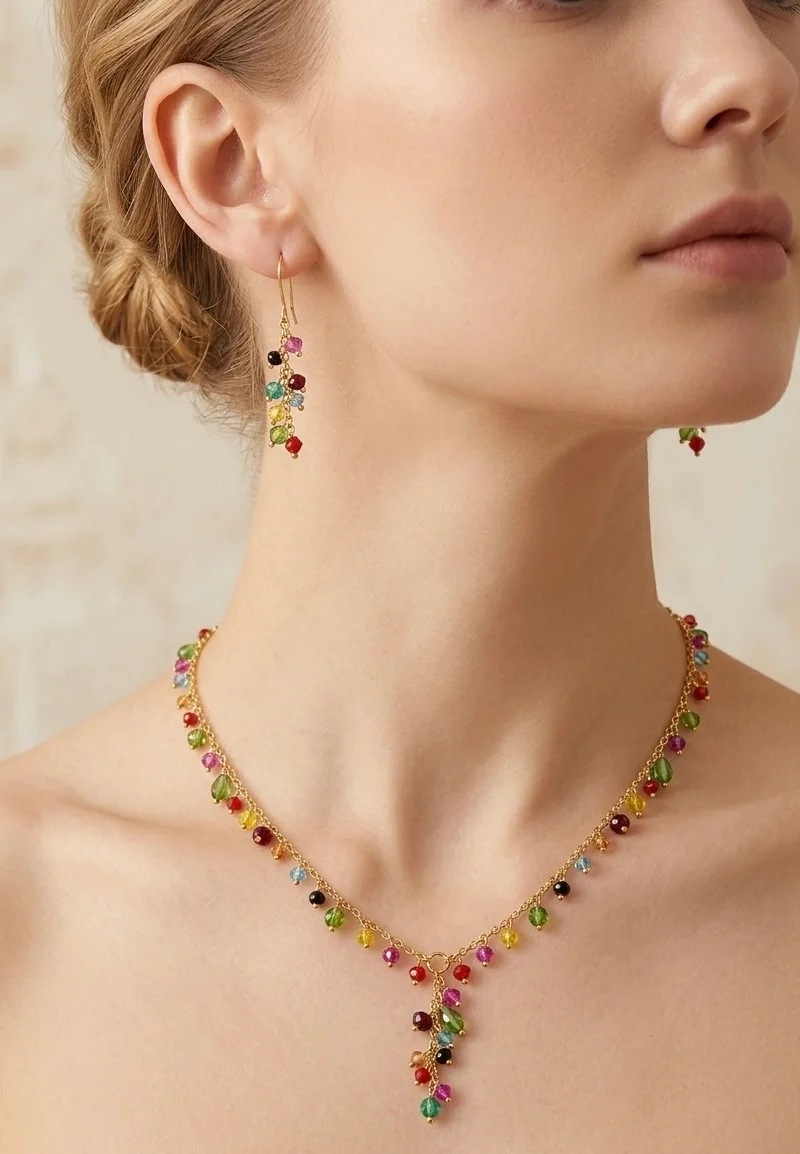 Gold plated chain with multi color crystals paired with earrings and bracelet.