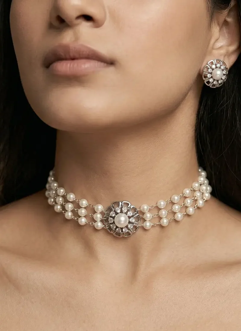 Silver chain with three-layer shell pearls, zircon stone pendant, and matching earrings.