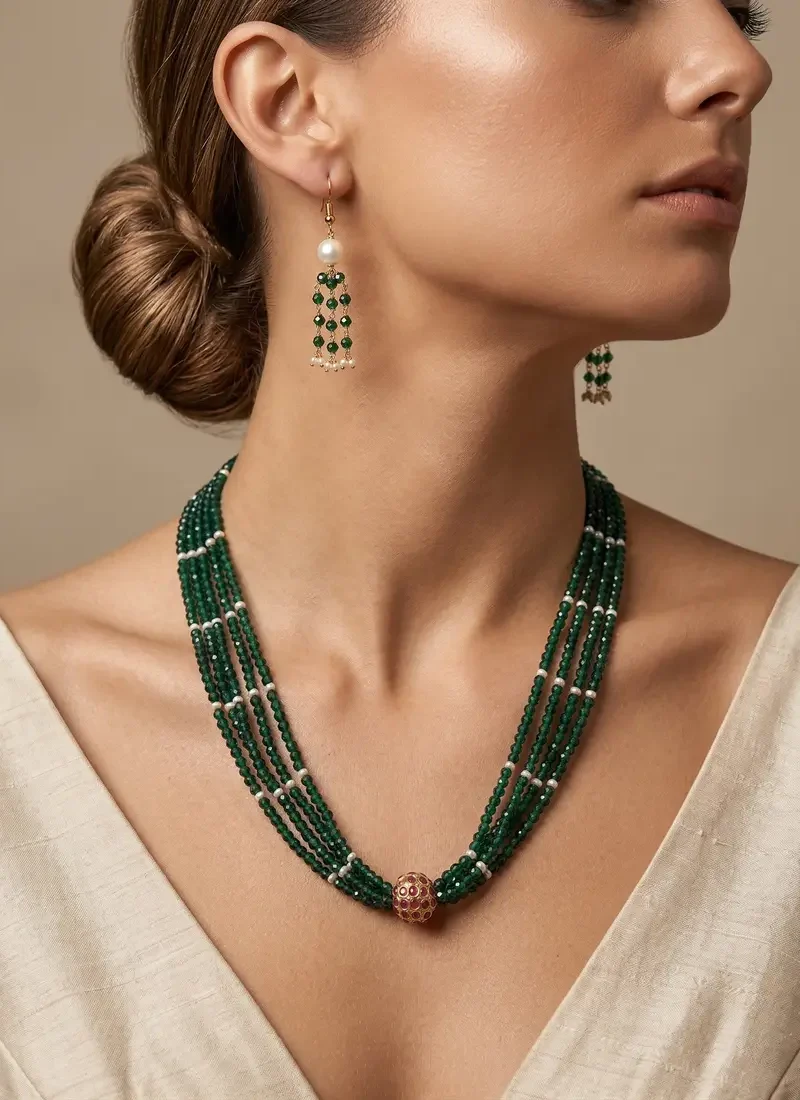 Olive green crystal necklace featuring a shell pearl accent and a polished golden ball pendant